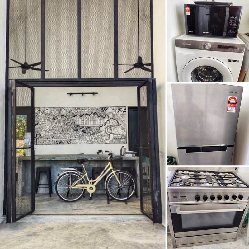 The common hall: steel-framed glass doors, mural, concrete kitchen counter, house bicycle, and full appliances